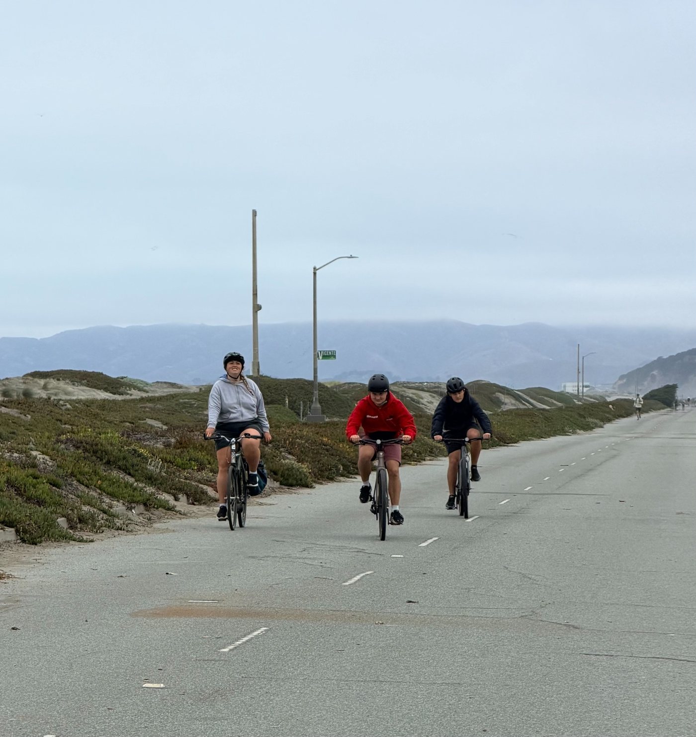 Children and a bike instructor riding bicycles during a group bike lesson in San Francisco
