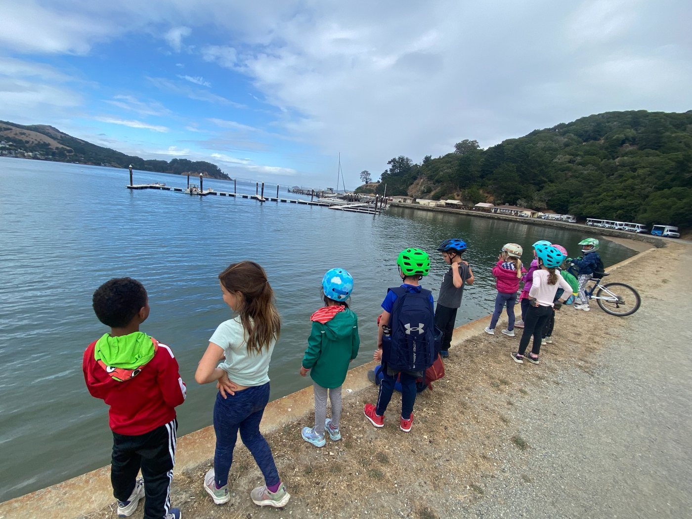 Children wearing helmets during a group bicycle lesson and outdoor ride near San Francisco