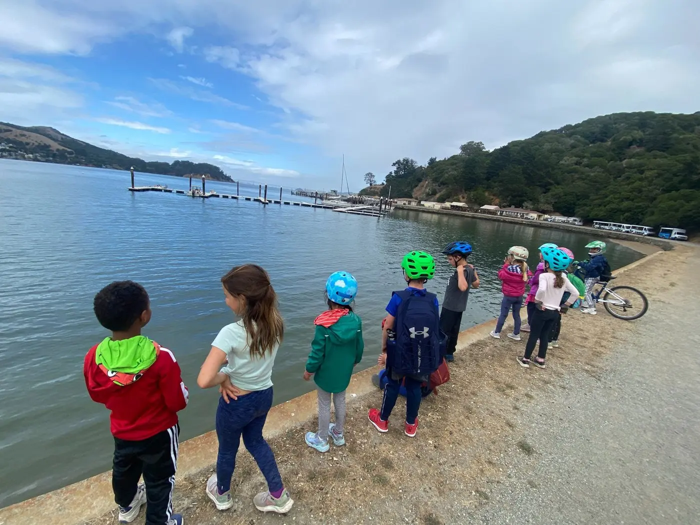 Children wearing helmets during a supported small-group bicycle ride in San Francisco