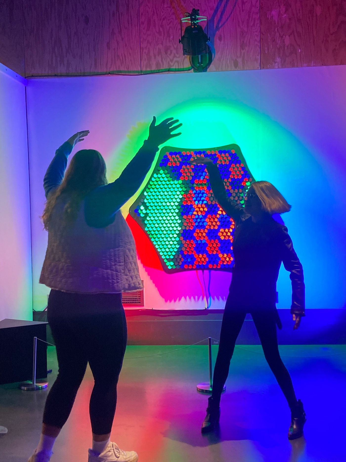 Participant and Olivia exploring a colorful interactive exhibit