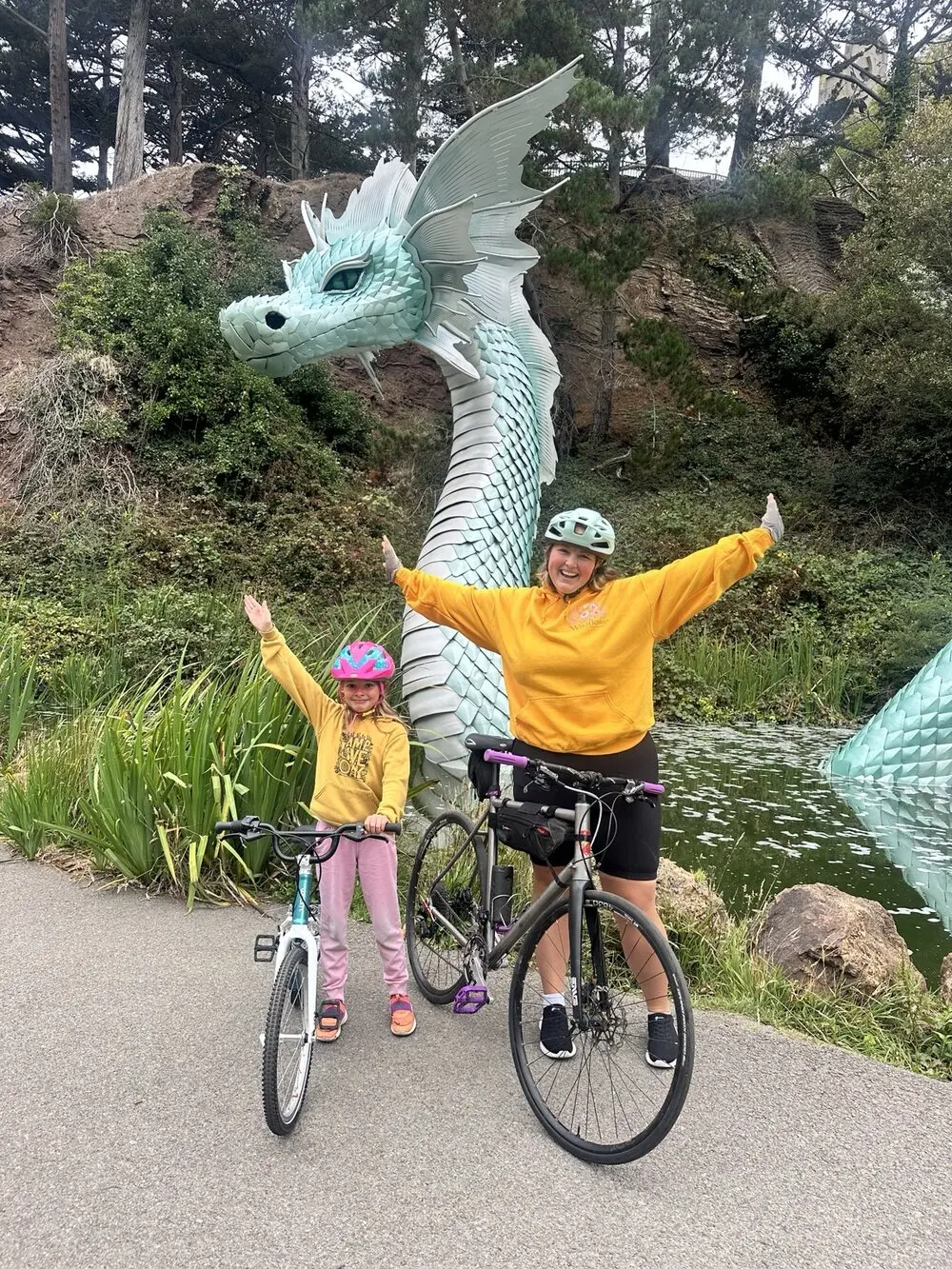 Olivia and a young rider smiling with their bicycles during an individualized bike lesson in San Francisco